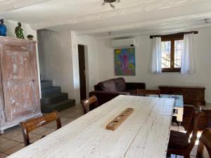 a living room with a wooden table and chairs at Casa delle Befane in Aurigeno