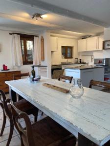 a kitchen with a table with chairs and a counter top at Casa delle Befane in Aurigeno