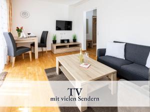 a living room with a couch and a table at Liggeringen in Radolfzell am Bodensee