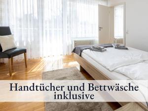 a bedroom with a bed and a chair and a window at Liggeringen in Radolfzell am Bodensee