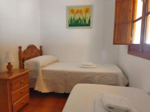 1 dormitorio con 2 camas, vestidor y ventana en Sol y Mar, en Isla Cristina