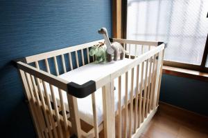 a crib with two stuffed animals on top of it at Pufuka Inn Skytree in Tokyo