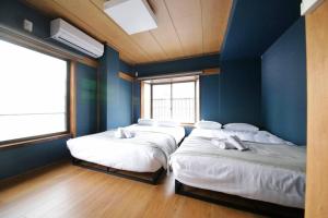 Tempat tidur dalam kamar di Pufuka Inn Skytree