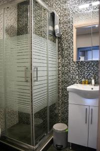 a bathroom with a shower and a sink at VILLA KOSTAS in Chaïdeftón +18 photos