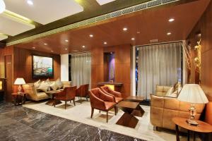 a lobby with couches and chairs and tables at Comfort Inn Insys in Bangalore