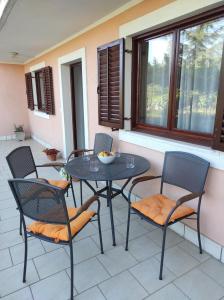 a table and chairs sitting on a patio at Apartman Poldrugovac in Labin