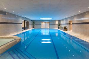 a swimming pool with a blue floor and blue walls at Best Western Plus The Connaught Hotel and Spa in Bournemouth
