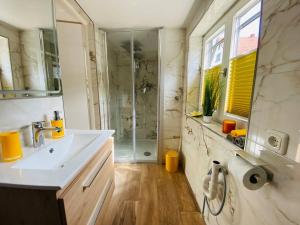 a bathroom with a sink and a shower at Allgäuerferienwohnung in Sulzberg