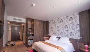a bedroom with a bed and a wall mural at Best Western Premier Le Patio des Artistes Wellness Jacuzzi in Cannes
