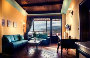 a living room with a couch and a table at Kallisti Hotel in Potos
