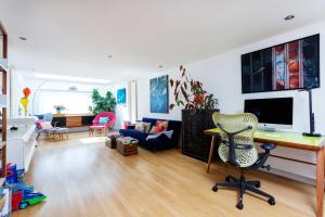 a living room with a desk and a chair at Veeve - Rubix Cube Mews in London