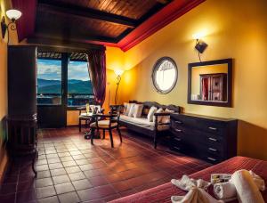 a living room with a couch and a table at Kallisti Hotel in Potos