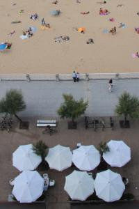 an aerial view of a beach with umbrellas at Hotel Niza in Donostia-San Sebastián