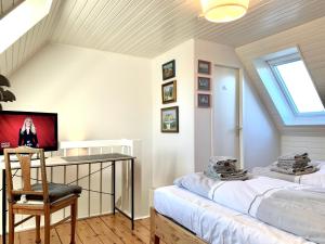 a room with two beds and a desk and a window at Ferienwohnung "Leena" in Sankt Peter-Ording