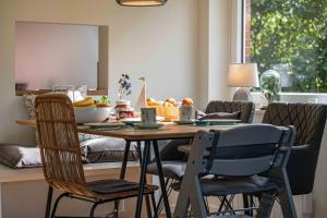 a dining room table with chairs and a bowl of fruit at Ferienhaus RH "Achter de Dün" in Sankt Peter-Ording