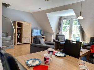 a living room with a dining table and a living room at Zum Leuchtturm - Ferienwohnung 3 in Sankt Peter-Ording