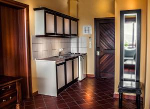 a kitchen with a sink and a counter top at Kallisti Hotel in Potos