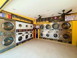 a washer and dryer room with multiple washing machines at D’Razna Inn in Kuala Terengganu