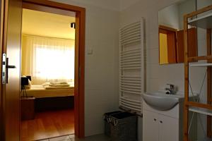 a bathroom with a sink and a bedroom at Hotel Bobr in Chomutov