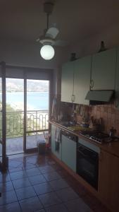 a kitchen with a view of the ocean from a balcony at Palazzo Nistico' in Soverato Marina