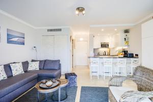 a living room with a couch and a table at Le Lido in Cagnes-sur-Mer