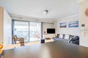 a living room with a table and a couch at Le Lido in Cagnes-sur-Mer