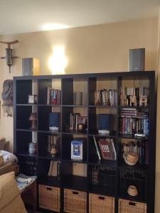 a black book shelf filled with books at La Launa apartamento rural in Trevélez +34 photos