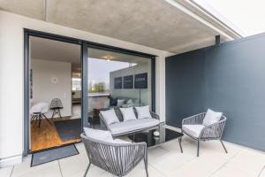 a living room with a couch and two chairs at Penthouse Ferienwohnung in Bahlingen