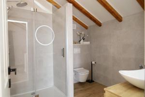 a bathroom with a shower and a toilet and a sink at Holiday house Nono in Sumartin +36 photos