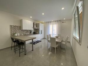 - une cuisine et une salle à manger avec une table et des chaises dans l'établissement Melitta apartment Giardini Naxos, à Giardini Naxos