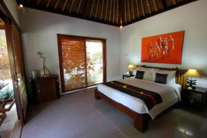 Voodi või voodid majutusasutuse Siddhartha Oceanfront Resort & Spa Bali toas
