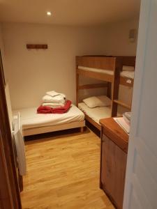 a room with two bunk beds and a wooden floor at The climber at Chamrousse #CU in Chamrousse
