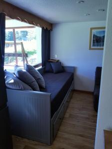 a bed in a room with a window at The climber at Chamrousse #CU in Chamrousse
