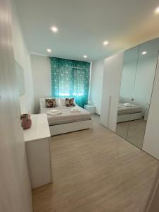 a bedroom with a bed and a mirror at Melitta apartment Giardini Naxos in Giardini Naxos