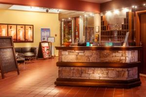 a bar in a restaurant with a stone wall at Kallisti Hotel in Potos