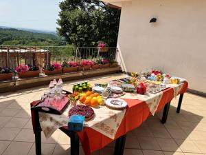 a table with food and drinks on a patio at B&B Il tramonto in Barbarano Romano