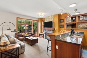 a kitchen and living room with a couch and a table at Capitol Peak 3312 in Aspen