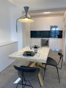 a kitchen with a table with wine glasses on it at “CapriOleum” esclusive place in Anacapri