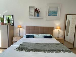 Łóżko lub łóżka w pokoju w obiekcie Residencial Algaida
