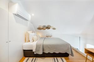 Ένα ή περισσότερα κρεβάτια σε δωμάτιο στο Porto Loft Living