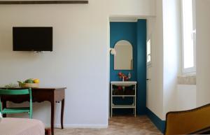 a bedroom with a desk and a mirror and a room with a bed at Agriturismo Morani in Santa Severa