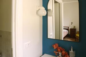 a bathroom with a mirror and a sink at Agriturismo Morani in Santa Severa