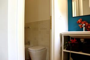 a bathroom with a toilet and a sink at Agriturismo Morani in Santa Severa