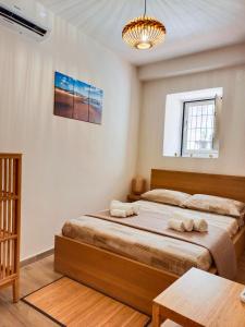 En eller flere senge i et værelse på EtnaCiTy Guest House Apartment