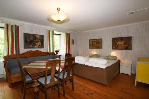 um quarto com uma cama e uma mesa com uma sala de jantar em Cozy holiday home located on Gotland em Slite