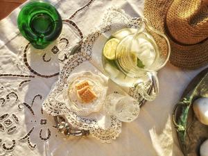a table topped with glasses and a green glass at Archontikon 1800 in Poros