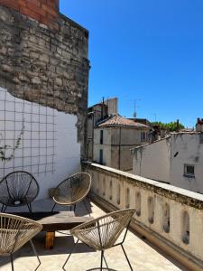 zwei Stühle und ein Tisch auf einem Gebäude in der Unterkunft Penthouse Apartment with Large Terrace and Veranda in Arles