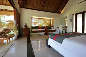 Voodi või voodid majutusasutuse Siddhartha Oceanfront Resort & Spa Bali toas