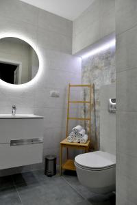 a bathroom with a toilet and a sink and a mirror at Ach To Tu! Apartament Zator in Zator