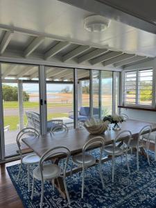a dining room with a wooden table and chairs at The Cove Cottage in Pemberton